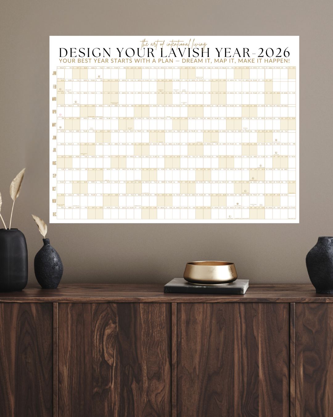 The 2026 Signature Wall Calendar in Sandstone Gold by Lavish Interiors, styled on a neutral wall as a large-scale home office visual anchor.