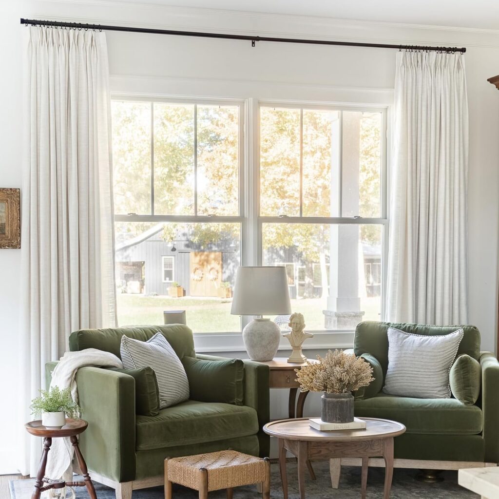 Airy living room with floor-to-ceiling white curtains and soft natural sunlight.