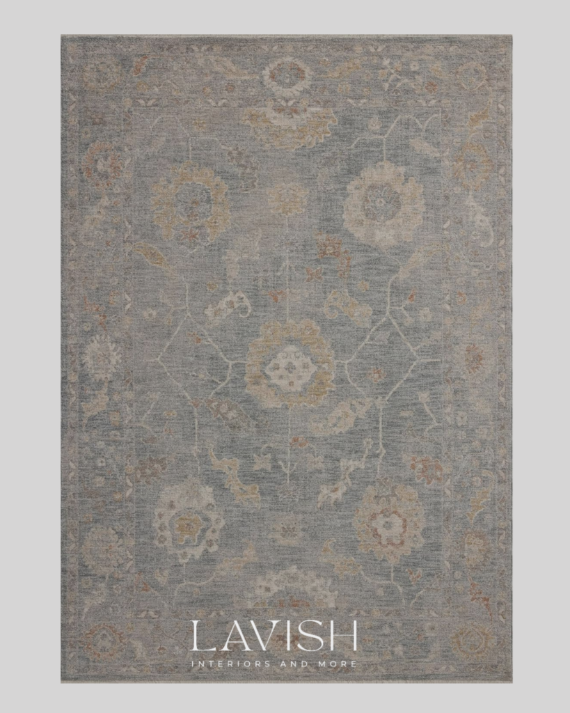 A high-end blue-gray Persian area rug with intricate vintage floral patterns and cream and gold accents.