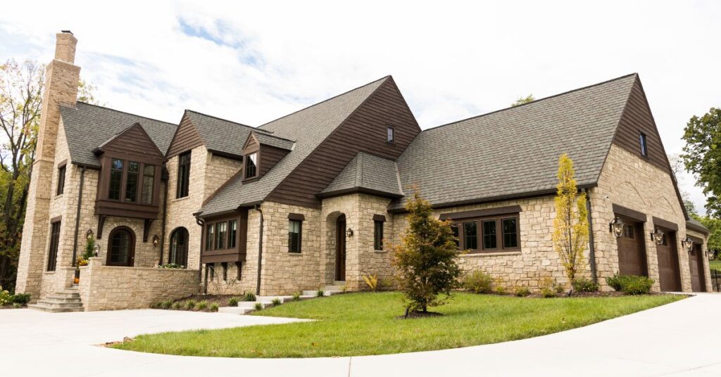 Luxury stone custom home exterior featuring custom architectural details and landscaping in St. Louis.